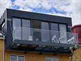 Balcony with steel construction suspended on tension rods from stainless steel