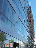 Façade covered with glass and Alucobond panels installed on aluminum frames