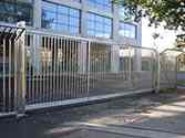 Cantilever sliding gate filled with vertical bars from stainless steel.