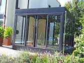 Glass conservatory constructed as a steel frame structure with double glazing and sliding door