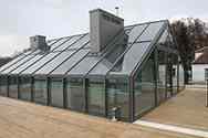 Glass conservatory built on roof of a house.