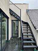 Winder stairs from painted steel with steps from steel grid