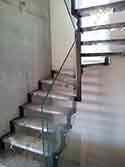 Winder stairs with steel supporting structure and wooden steps.
