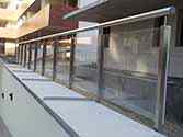 Stainless steel glass balustrade with safety glass infill at the entrance to the underground car park