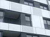 Alucobond facade panels, behind them balcony railings made of steel profiles