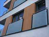 Juliet balconies with glass panels mounted to steel posts with clamps from stainless steel