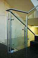Stainless steel glass balustrade with tubular, satin finish handrail and posts. Toughened glass infill