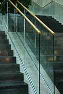 Frameless glass balustrade with wooden top handrail