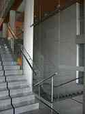 Frameless glass balustrade with stainless steel, high polished, tubular handrail on stairs