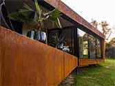 Terrace with façade cladded with corten steel cassettes