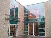 Glass canopies over main entry and fire door