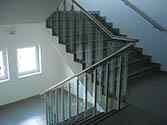 Stainless steel glass balustrade with toughened glass infill. High polished stainless tubular handrail
