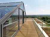 Glass conservatory Glass wall with glass panels in steel frame.