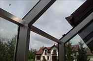 Glass panels mounted to supporting structure from stainless steel profiles