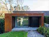 corten facade, entrance to the house cladded with corten steel panels