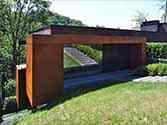 entrance to the house and a side jutty cladded with corten steel panels