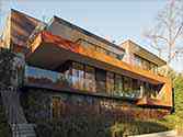 façade cladding with corten steel panels of rands of lower and upper terraces and side jutty