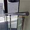 stainless steel high polished tubular handrail mounted to posts with handrail supports
