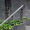 handrail from galvanized, powder painted steel on stairs at the building entrance