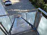 steel staircase, steps from aluminum sheet, stainless steel railing with glass
