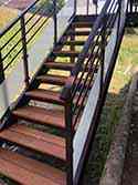 steps with wooden boards and steel railings with glass infill