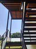 steel support structure, steps and landings covered with wooden boards and railings with glass filling