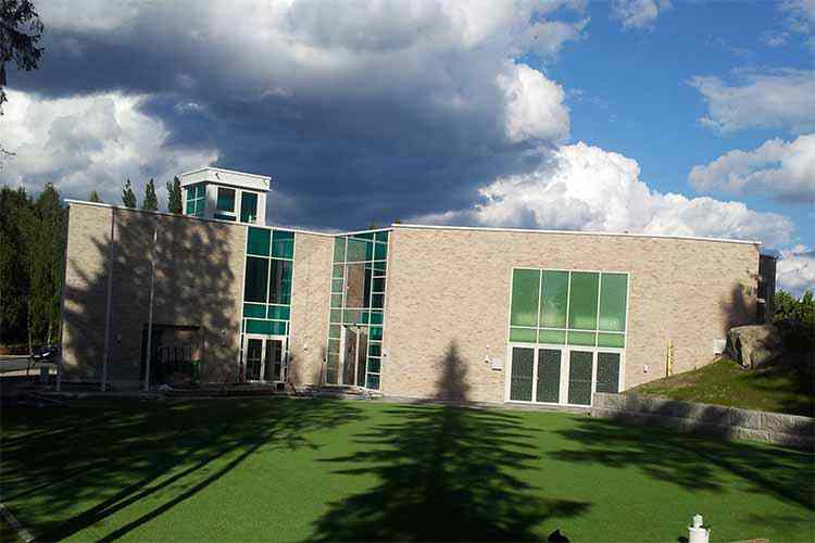 Façade cladding with glass panels installed on aluminum frames