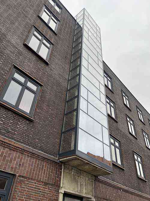 Façade cladding with glass panels installed on steel frames