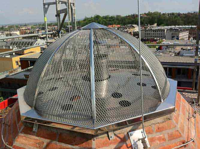 Stainless steel protective dome installed at the top of the restored chimney