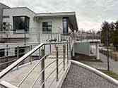 Stainless steel balustrade with horizontal rod infill on stairs and on wheelchair ramp